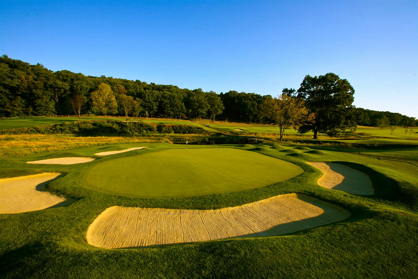 Golf course photograph of Omni Bedford Springs Resort in Pennsylvania, featuring classic green contours, bunkering, and surrounding countryside.